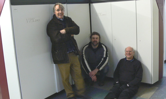Jim Austin, Richard Hind and Trevor Howard in front of a Fujitsu mainframe computer